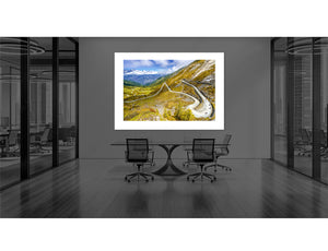 Colle Delle Finestre - Gravel Side art print displayed in a modern office setting, showcasing a scenic mountain road.